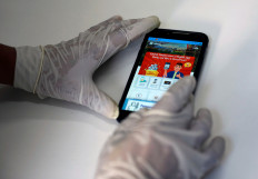 A migrant worker shows the MyMA app in his dormitory, amid the coronavirus disease (COVID-19) outbreak in Singapore May 15, 2020. The app caters to the needs of migrant workers and domestic helpers in Singapore. It provides news updates, electronic remittance, monitoring of daily temperatures and streaming of movies in Hindi and Bengali.   