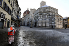An employee of the municipal company disinfects Piazza del Duomo, in Florence, on March, 21 2020, as part of the measures taken by Italian government to fight against the spread of the COVID-19, the novel coronavirus. 