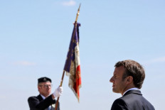 French President Emmanuel Macron (right) looks on in La-Ville-aux-Bois-les-Dizy, northern France on May 17, 2020, during a ceremony marking the 80th anniversary of the Montcornet battle (bataille de Montcornet), in the Aisne department, where a yet unknown General, Charles de Gaulle, led an armored division against Nazi Germany's invasion of France.