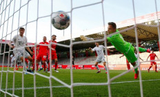 Bayern Munich's French defender Benjamin Pavard (hidden) scores their second goal during the German first division Bundesliga football match FC Union Berlin v FC Bayern Munich on May 17, 2020 in Berlin, Germany as the season resumed following a two-month absence due to the novel coronavirus COVID-19 pandemic.Football clubs in Germany's top two divisions on Tuesday agreed to plans drawn up by the league which could allow the partial return of fans to stadiums from mid-September, despite the coronavirus pandemic.