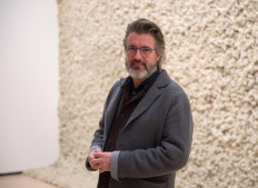 Danish-Icelandic artist Olafur Eliasson poses in front of his artwork 'Moss wall' during a presentation of the 'Olafur Eliasson: In real life' exhibition at the Guggenheim Museum in the northern Spanish Basque city of Bilbao on February 13, 2020.