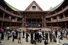 In this file photo taken on April 23, 2014, members of the cast of a new touring production of William Shakespeare's 'Hamlet' perform during a photocall at the Globe theater in London. 