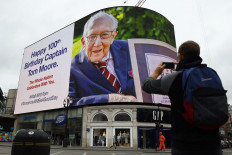 A birthday message for Captain Tom Moore is displayed on the advertising boards in Piccadilly Circus in London on April 30, 2020 as the country celebrates his 100th birthday.
