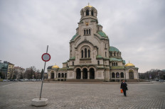 An elderly woman wearing a protective face mask walks in front of the Aleksandar Nevski Cathedral in Sofia on March 31, 2020 after all public gardens, children's playgrounds and open-air sports facilities in Bulgaria were sealed to prevent social gathering, allowing only dog owners solitary walks, in a move aimed at curbing the spread of the COVID-19 pandemic, caused by the novel coronavirus.
