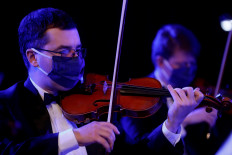 Masked Ukrainian orchestra makes concert recording as lockdown eases