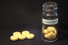 This handout picture released by Japan's Fujifilm Corp. on October 22, 2014 in Tokyo shows Avigan tablets -- approved as an influenza drug in Japan. 