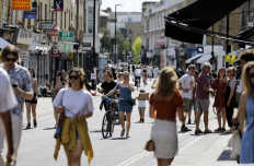 People get out in the sunshine in broadway market, Hackney, north east London on May 20, 2020, as temperatures in the capital are expected to reach 28 Celsius degrees.