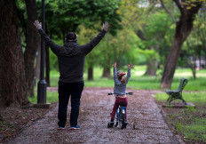 A young girl exercises beside a man in a park in Seville on April 26, 2020 amid a national lockdown to prevent the spread of the COVID-19 disease. 