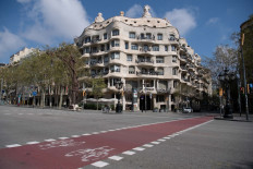 The empty street is pictured in front of Spanish architect Antonio Gaudi's 'Casa Mila' building, commonly known as 'La Pedrera', in Barcelona on March 19, 2020. 
