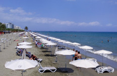 People gather at Mackenzie beach in the coastal city of Larnaca on the Mediterranean island of Cyprus on May 23, 2020. 