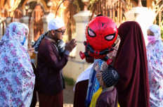 Communities meet with each other after Idul Fitri prayers at the Jami 'Al-Makmur Mosque, Leuwinanggung in Depok, West Java, in May, 2020.
