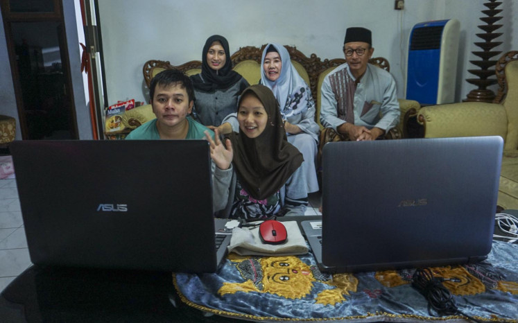 A family holds a video chat during Idul Fitri in Pati, Central Java, on Sunday.