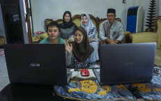 A family in Pati, Central Java, uses a video conferencing application on a laptop on 5 May, 2020.  