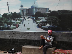 A pedestrian takes a rest outside Istiqlal Mosque in Pasar Baru, Central Jakarta. The mosque has been closed to the public since the coronavirus pandemic hit Jakarta. JP/Sutrisno Jambul