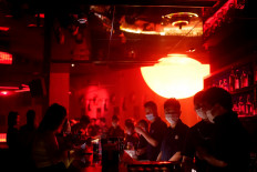 People wear face masks at a nightclub after it reopened following a shutdown due to the coronavirus disease (COVID-19) outbreak, in Shanghai, China May 22, 2020. 
