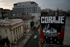 Cuban artist 'Mr Myl' paints a mural which reads in Spanish: 'Courage', amid concerns about the spread of the coronavirus disease (COVID-19) outbreak, in downtown Havana, Cuba, May 20, 2020. 