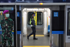 An Indonesia Military (TNI) soldier stands guard at the Bundaran HI MRT station in Jakarta on May 26, 2020.