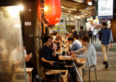 People enjoy drinks and dinner at a Japanese izakaya pub, as the spread of the coronavirus disease (COVID-19) continues, after the Japanese government lifted the state of emergency, at Ueno shopping and amusement district in Tokyo, Japan May 26, 2020. 