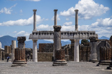 People (rear L) visit the archaeological site of Pompeii on May 26, 2020, as the country eases its lockdown aimed at curbing the spread of the COVID-19 infection, caused by the novel coronavirus. 