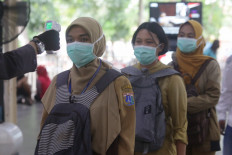 Commuter line passengers wait for the train at Manggarai Station, Jakarta, on Tuesday.