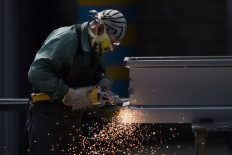 An employee works manufacturing steel coffins at the Platinum Casket Company in Los Reyes Acaquilpan, Mexico on May 28, 2020, amid the new coronavirus pandemic. 