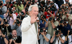 In this file photo US actor and director Clint Eastwood waves as he poses during a photocall for his film 'The Exchange' at the 61st Cannes International Film Festival on May 20, 2008 in Cannes, southern France. 