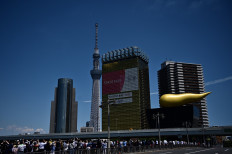 Blue Impulse aerobatic demonstration team of Japan Air Self-Defence Force flies over Tokyo Skytree to thank the medical workers in Tokyo on May 29, 2020.
