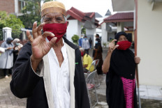 A senior citizen at the Rumoh Seujahtra Geunaseh Sayang nursing home in Banda Aceh, Aceh poses while wearing a mask as an effort to prevent COVID-19 transmission on May 1, 2020.