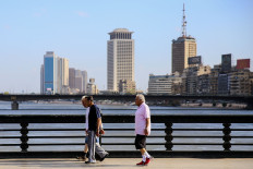 Elderly men walk along the Kasr el-Nil bridge connecting the island district of Zamalek to the city centre of Egypt's capital Cairo, early on May 24, 2020 on the first day of Eid al-Fitr, the Muslim holiday which starts at the conclusion of the holy fasting month of Ramadan. 
