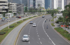 Traffic is quieter than usual on Jl. Jenderal Sudirman in Jakarta on May 31, 2020 because of movement restrictions imposed by the government. In July 2021, after a spike in COVID-19 cases and deaths, the government enforced new curbs to reduce office work and hence the risk of contagion.