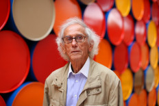 Bulgarian artist Christo poses in front of the monumental 'Mastaba' art work at the Maeght Foundation (Fondation Maeght) on the opening day of the exibition, in Saint-Paul-de-Vence, southeastern France, on June 4, 2016. 