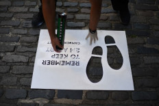 Signs are prepared to facilitate social distancing in Camden Market in London on June 1, 2020 as outdoor markets reopen following an easing of the lockdown restrictions during the novel coronavirus COVID-19 pandemic. - Some non-essential stores, car dealerships and outdoor markets in Britain on June 1 were able to reopen from their COVID-19 shutdown in an easing of coronavirus lockdown measures. 