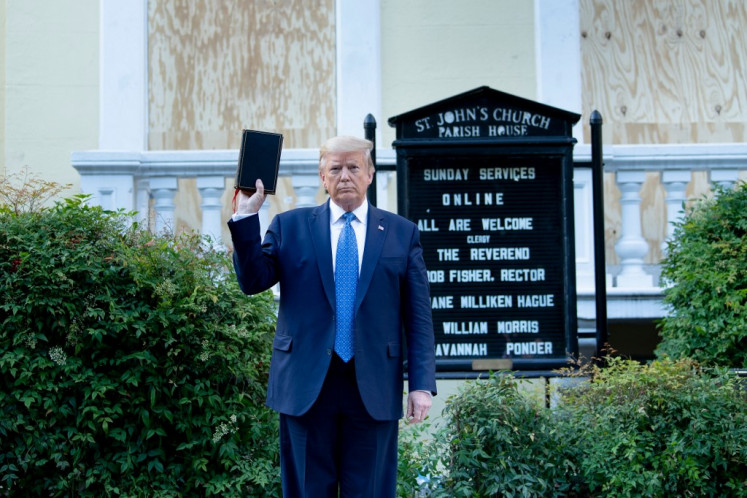 US President Donald Trump holds a Bible while visiting St. John's Church across from the White House after the area was cleared of people protesting the death of George Floyd June 1, 2020, in Washington, DC. US President Donald Trump was due to make a televised address to the nation on Monday after days of anti-racism protests against police brutality that have erupted into violence.