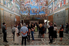 People wearing protective face masks visit the Sistine Chapel at the Vatican Museums as they reopen amid the spread of the coronavirus disease (COVID-19) at the Vatican on June 1, 2020. 