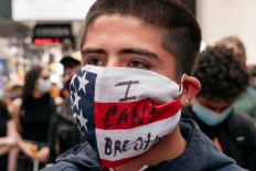 A young man wears a mask that reads "I Can't Breathe" during a rally in Times Square denouncing racism in law enforcement and the May 25 killing of George Floyd while in the custody of Minneapolis, on June 1, 2020 in New York City. Days of protest, sometimes violent, have followed in many cities across the country.   AFP/Getty Images/Scott Heins 