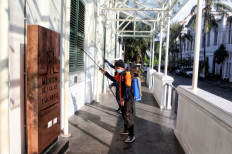 Preventive reinforcement: Public sanitation workers disinfect a historic building on Tuesday in the Kota Tua area of West Jakarta as a safeguard against the spread of SARS-CoV-2, the virus that causes COVID-19.