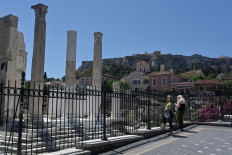 People look at the archaeological site of hadrian's library in Athens on June 4, 2020, as Greece eases lockdown measures taken to curb the spread of the COVID-19 (the novel coronavirus). 