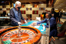 Tilak Fernando places a bet at a roulette table during the reopening of the Bellagio hotel-casino, closed earlier to slow the spread of the coronavirus disease, in Las Vegas, the United States, on June 4, 2020.