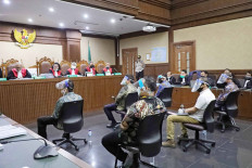 Defendants wear face shields and masks as they sit in chairs configured to comply with physical distancing rules on Wednesday, during a hearing of the Asuransi Jiwasraya trial at the Jakarta Corruption Court. JP/Dhoni Setiawan