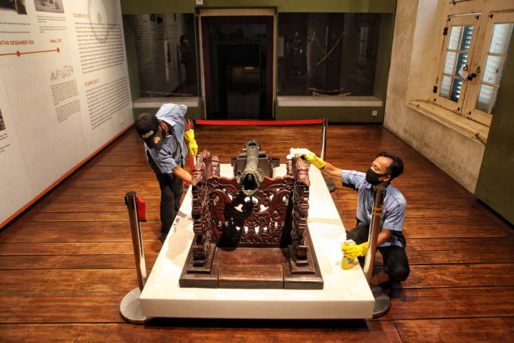 Cleaning staffs clean an art collection at Jakarta History Museum, also known as Fatahilah Museum, Jakarta, on June 6, 2020. DKI Jakarta govenrment allows a number of tourist attractions such as museums to be able to operate again from June 8, 2020 as Jakarta enter a transition phase of the large-scale social restrictions (PSBB).