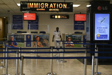 An immigration officer walks at the arrival terminal of the Bandaranaike International airport in Katunayake on March 19, 2020, following the Sri Lankan government order to ban all incoming flights for two weeks as preventive measure against the COVID-19 coronavirus.