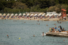 People enjoy a sunny day on a beach during the official reopening of beaches to the public in Athens on May 16, 2020. 