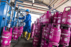 A worker refills gas cylinders at Pertamina's LPG bulk filling and transportation station (SPPBE) in Bandung, West Java, on June 9, 2020.
