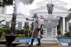 History in the making : A sanitary worker sprays disinfectant at the National Museum as part of efforts to prevent the spread of COVID-19..