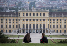 Young women enjoy their picnic in a garden of Schoenbrunn palace, the main summer residence of the Habsburg rulers, on a cloudy late evening in Vienna, Austria on June 09, 2020.
