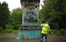 Council workers clean a statue of Britain's Queen Victoria that was defaced in Woodhouse Moor Park in Leeds, northern England on June 10, 2020. - Britain has seen days of protests sparked by the death in police custody of George Floyd, an unarmed black man, in the United States. 