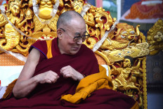 Tibetan spiritual leader the Dalai Lama gestures during the fourth day of a series of teachings in Bodhgaya on January 5, 2020.
