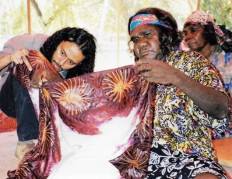 Up close: Indonesian batik artist Agus Ismoyo (left) and an artist from Utopia hold up a batik fabric.