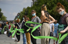 Berliners form socially-distanced human chain against racism