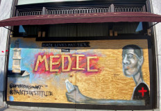 A mural designed by Washington-based artist Levi Robinson showing a black medic adorns the exterior wall of a restaurant on the recently named Black Lives Matter Plaza in Washington, DC, US June 14, 2020.